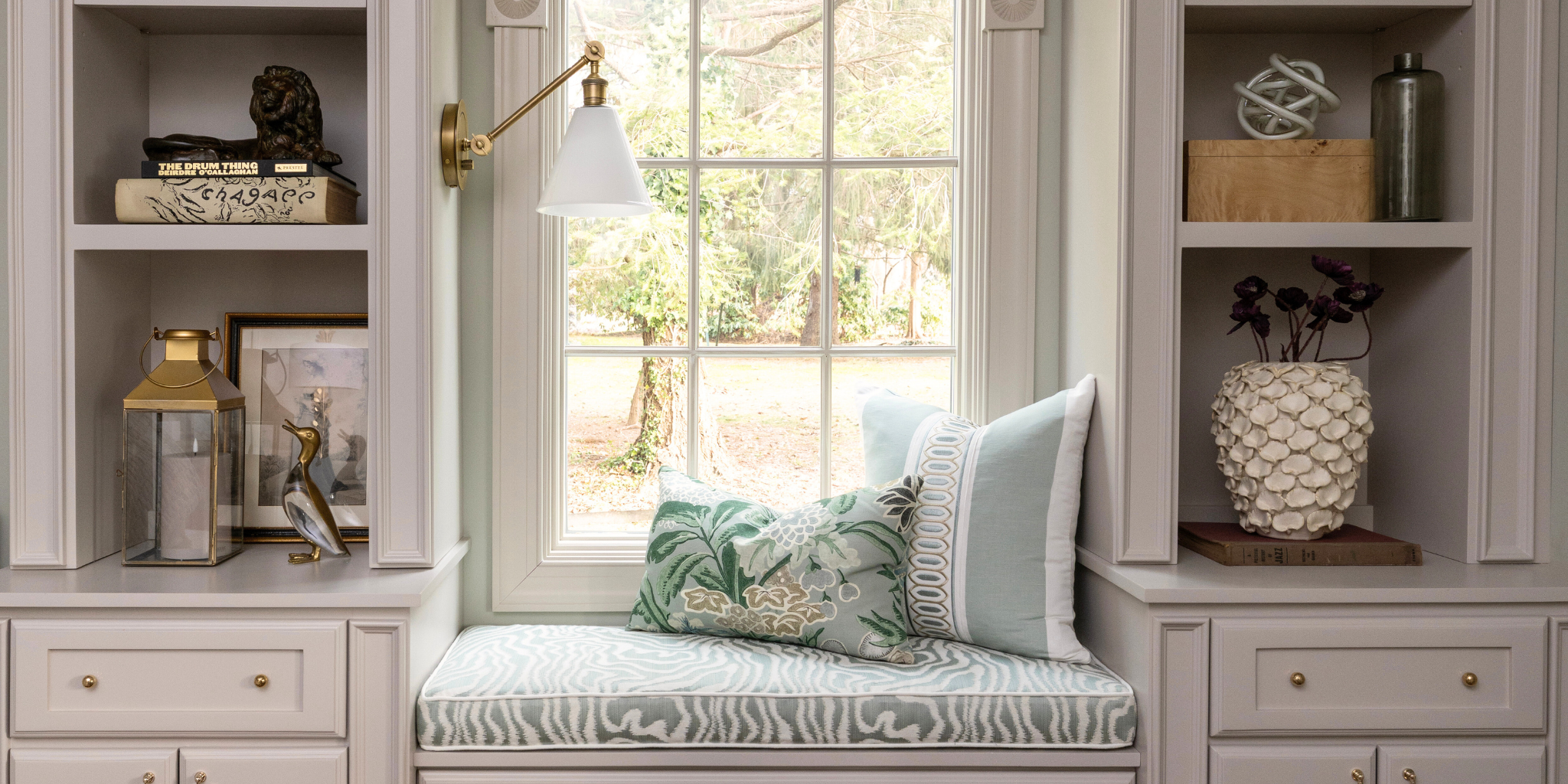 Decorative interior with a bench, pillows, and shelves in a home setting.